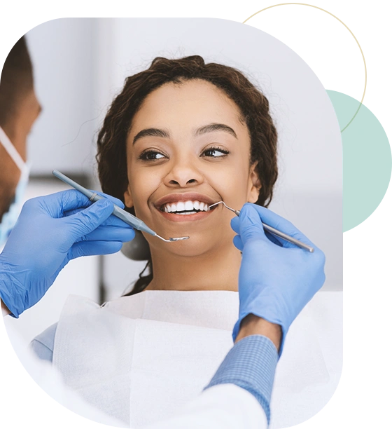Lady in dentist chair looking at her doctor with smile