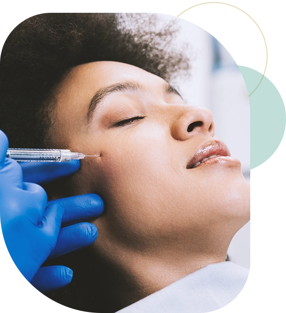 Attractive young African woman is getting a rejuvenating facial injections.