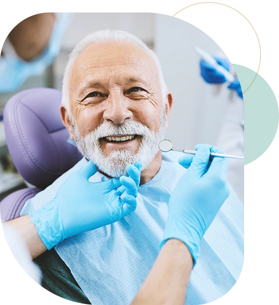 Happy mature man during teeth check-up at dental clinic.