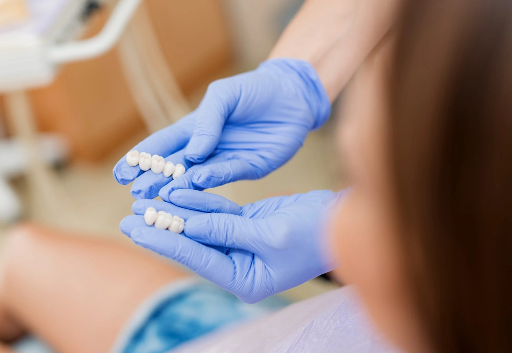 Dentist showing porcelain crowns to the patient.